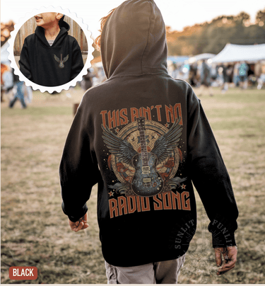 A person wearing a black hoodie with a graphic design of a guitar and the text